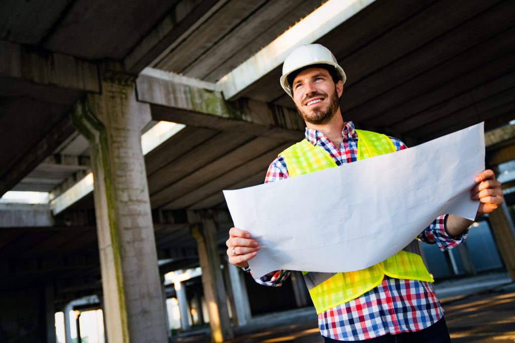 Portrait of construction engineer, architect working on building site