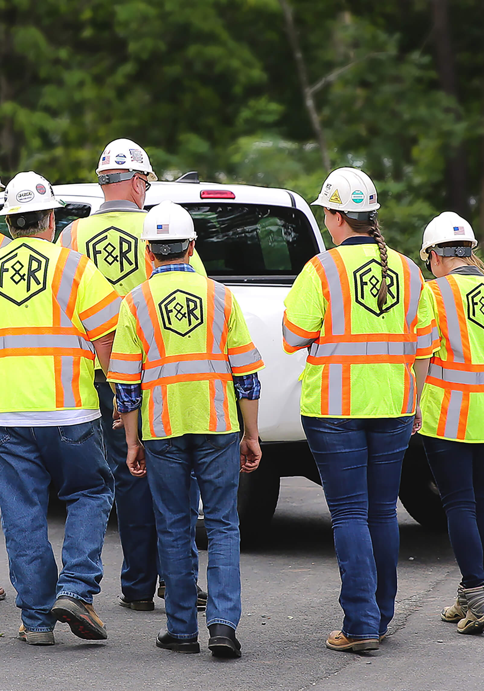 F&R is an engineering consulting firm in the Mid-Atlantic; a group of F&R employees walks on a project site