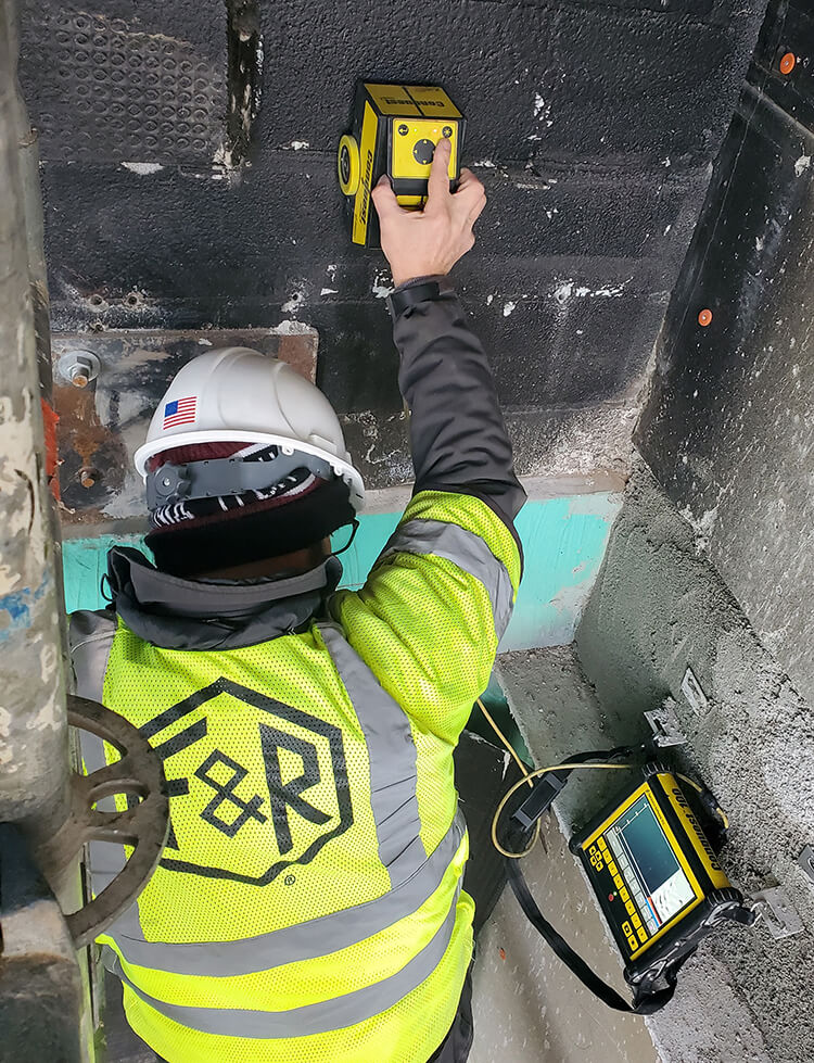 An F&R inspector locates reinforcing steel in CMU