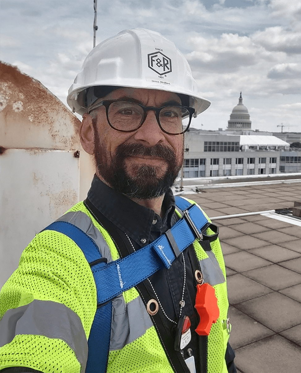 An F&R employee takes a break for a selfie with the U.S. Capitol Building in the background