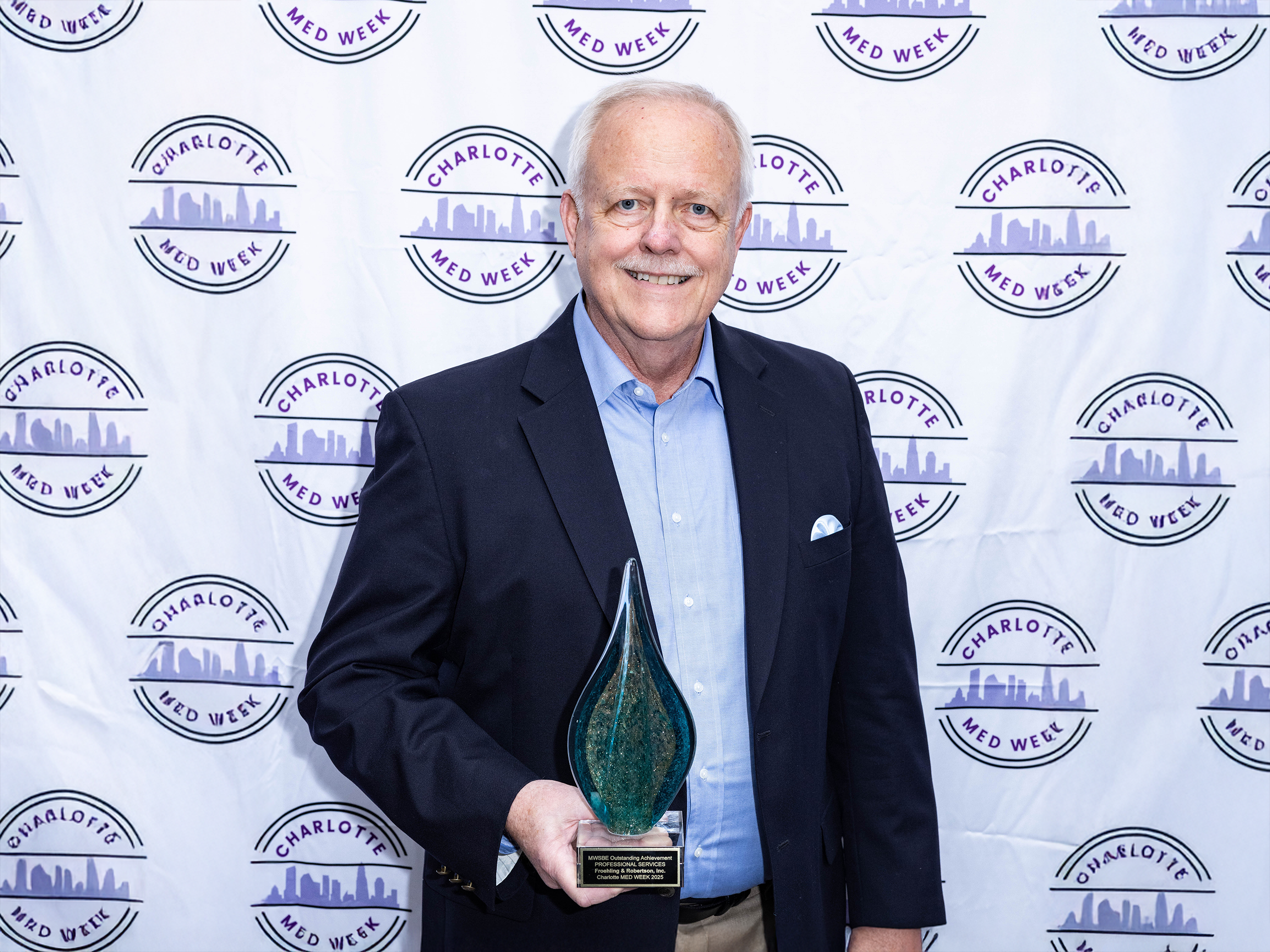 Roy Lindland accepts the Charlotte Med Week MWSBE Award on F&R's behalf
