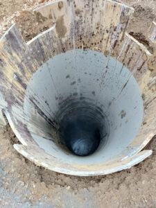 Aerial view of caisson installation in soil with shallow groundwater conditions