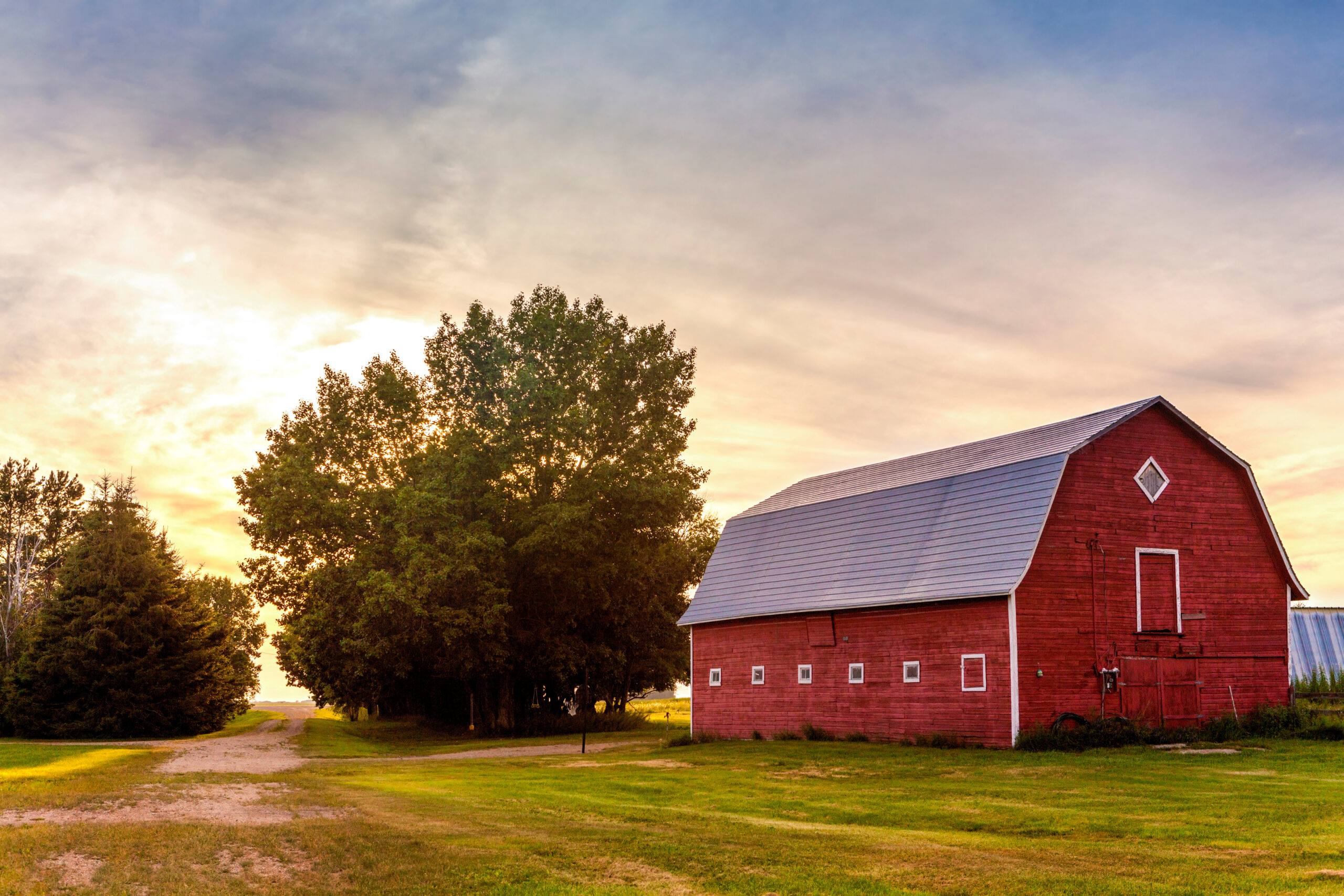 Red barn against sunny sky